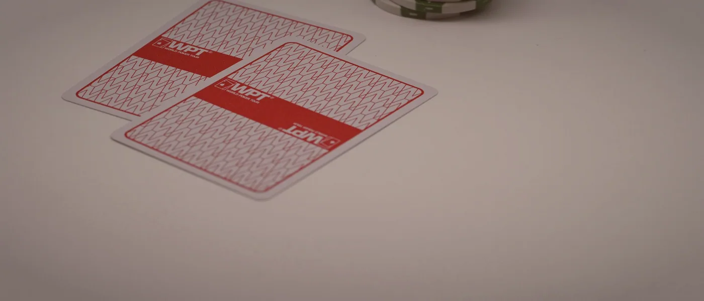 A hand of five hundred being dealt across green felt